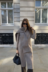 a lady in a grey wool alpaca coat and a grey scarf